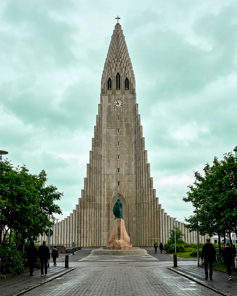 Hallgrímskirkja church's tall stepped concrete facade and spire against pale sky